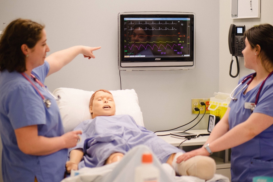 nursing students practice on the mannikin in the health care simulation lab
